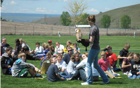 Group of students with owl and handler
